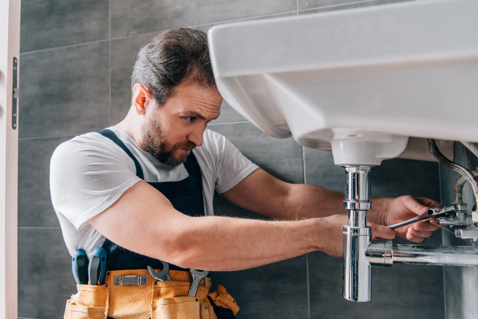 plumber fixing sink