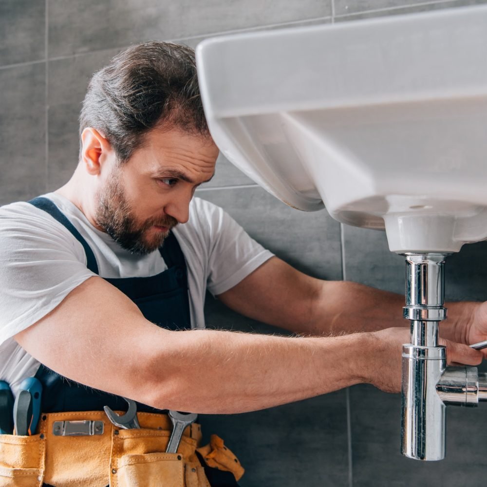 plumber fixing sink